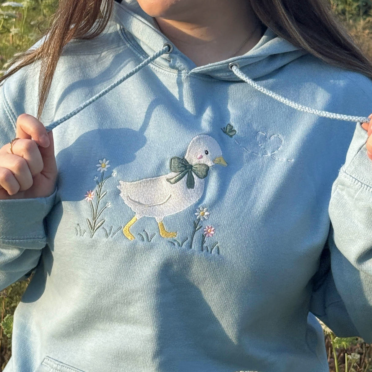 Duck in the flower garden embroidered adult hoodie