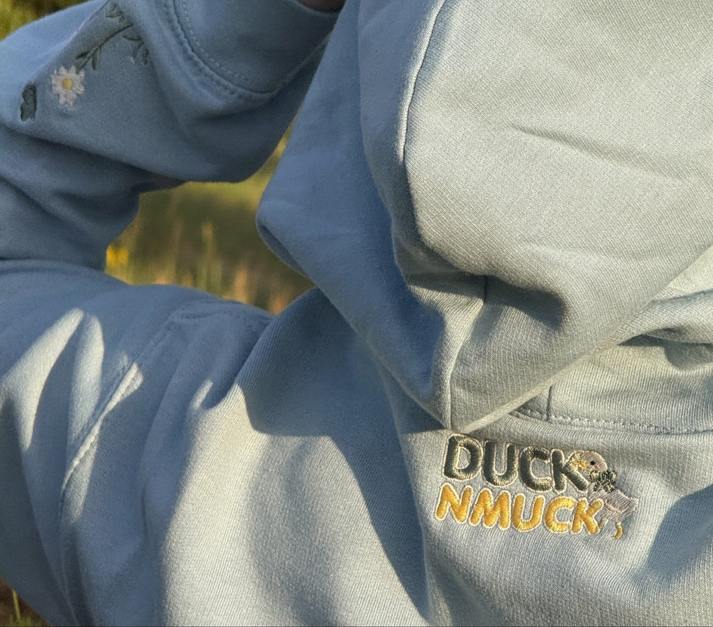 Duck in the flower garden embroidered adult hoodie