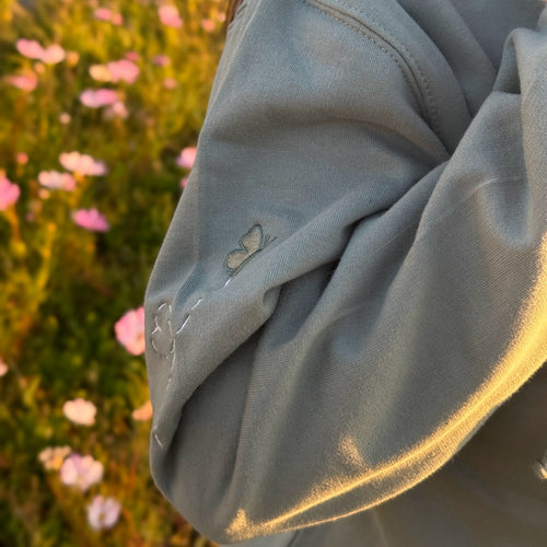 Duck in the flower garden embroidered adult hoodie