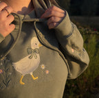Duck in the flower garden embroidered adult hoodie